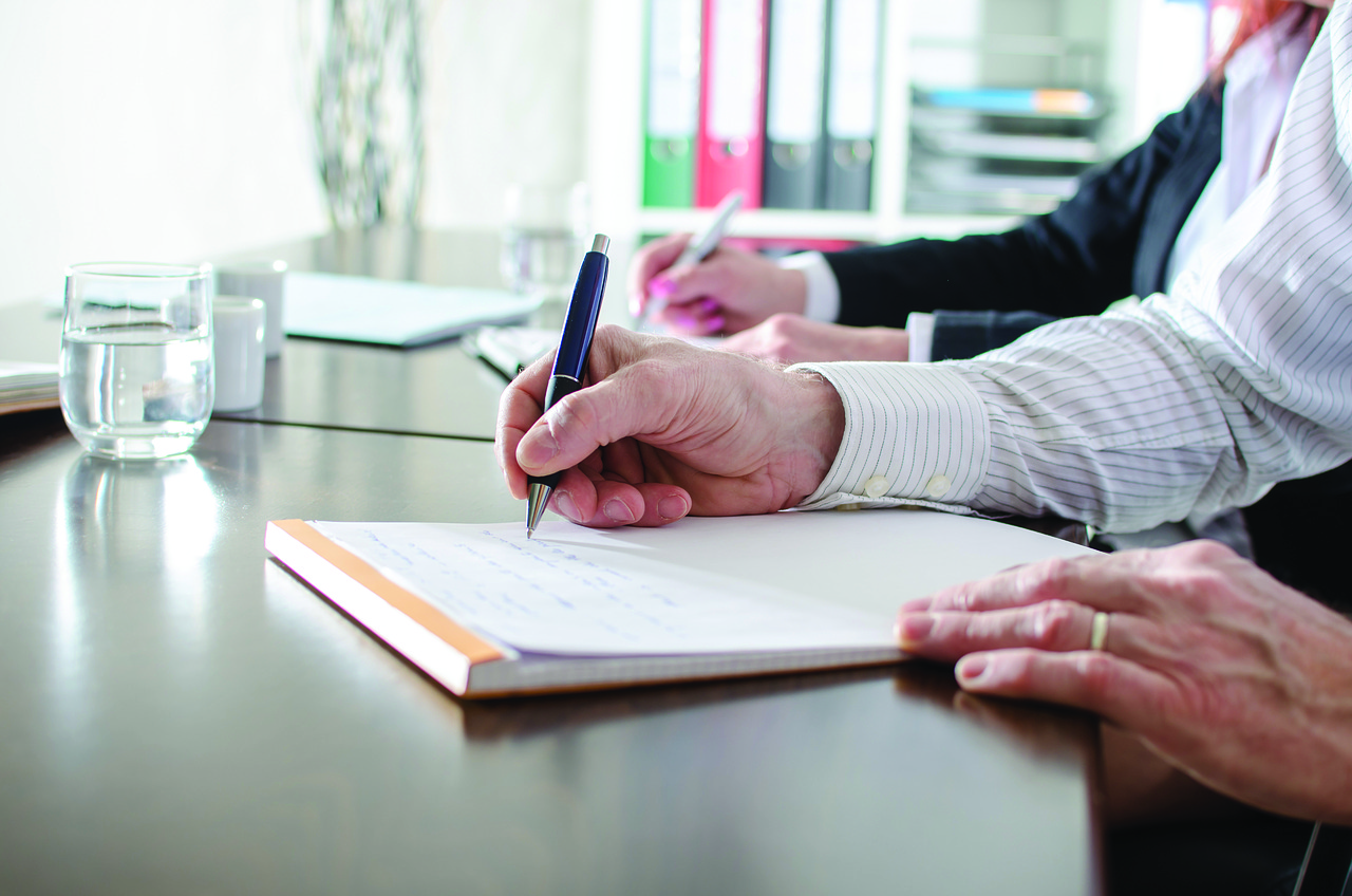 Man taking notes on communication strategy